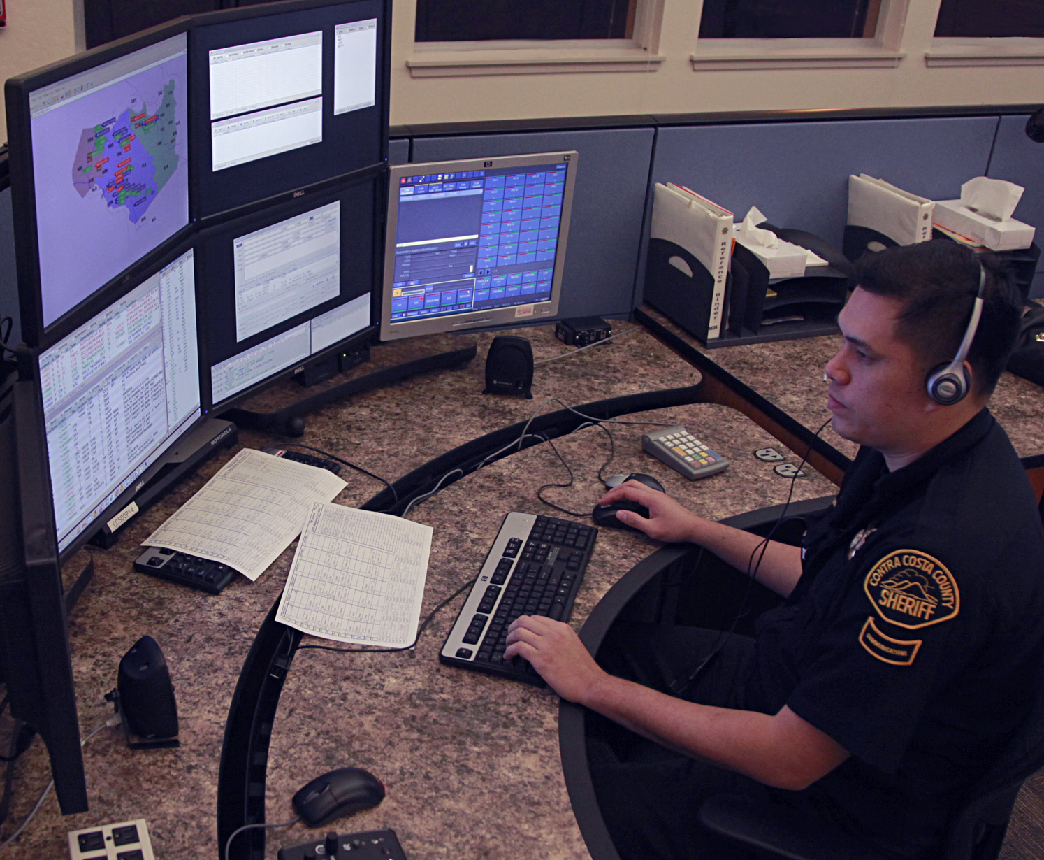 Photo of dispatcher in front of computer
